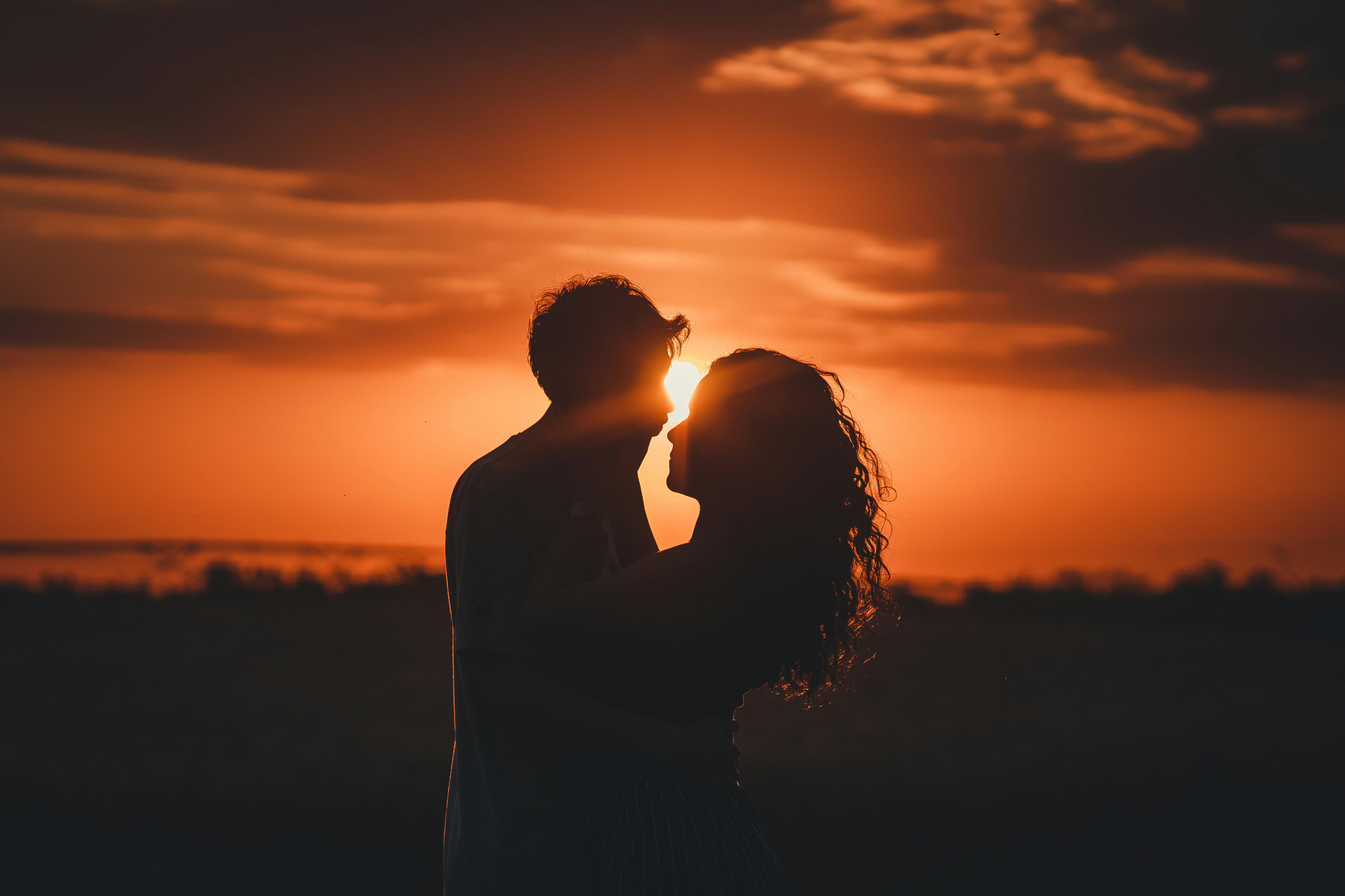 Couple in an intimate embrace at sunset
